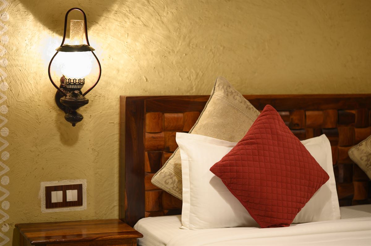 Antique brass lantern sconce on ochre plaster wall