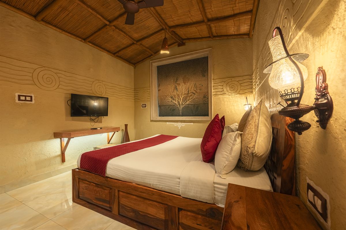 Yamuna Suite - warm-lit bedroom with traditional sconce lamps